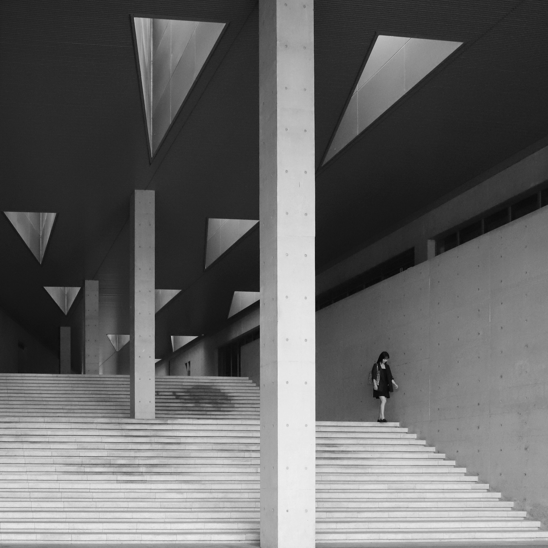 woman standing beside wall on stairs
